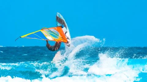 Windsurfer making an acrobatic jump in the waves Stock Photos