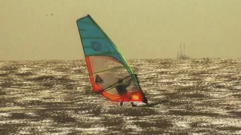 Windsurfer in orange sunset Stock Footage 95045084
