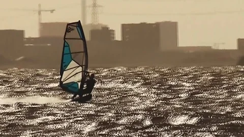 Windsurfer in orange sunset Stock Footage 95438908