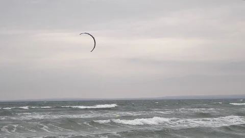Windsurfer with parachute sail the wind and glide the waves. Stock Footage 100144231