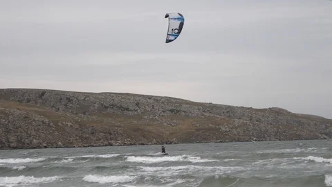 Windsurfer with parachute sail the wind and glide the waves. Stock Footage 100144673