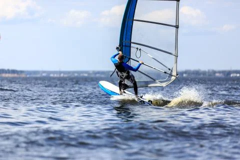 Windsurfer passing by Stock Photos