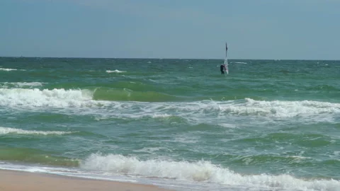 Windsurfer rides the sea waves in windy weather Stock Footage 183003146