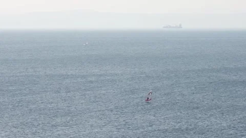 Windsurfer rides waves on the open Adriatic Sea Stock Footage 344765379