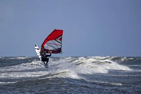 Windsurfer riding a wave Stock Photos