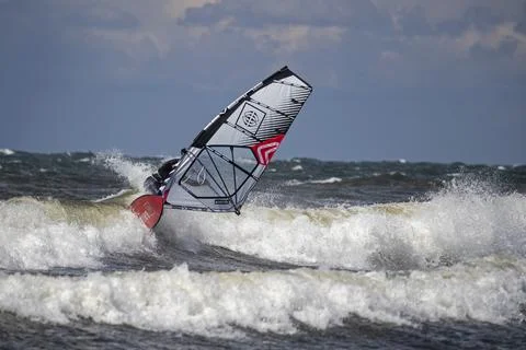 Windsurfer riding a wave Stock Photos