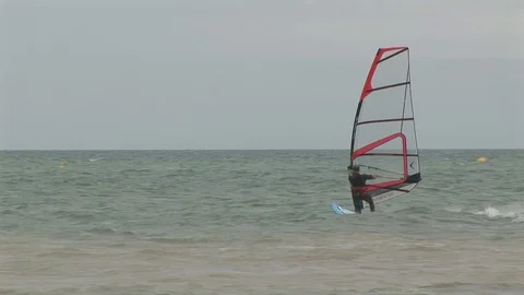 Windsurfer riding the waves on Juno beach, Normandy, France Stock Footage 102350387