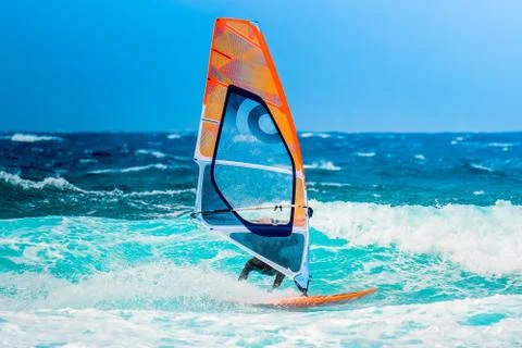 Windsurfer riding the waves Stock Photos