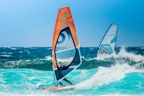 Windsurfer riding the waves Stock Photos