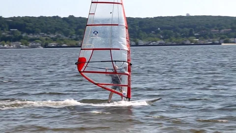 Windsurfer Sailing into Sun Stock Footage 87877362