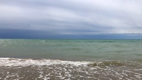 Windsurfer on sea line, soft waves cloudy sky Stock Footage 93279845