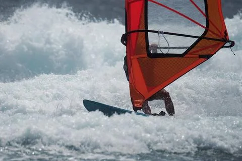 Windsurfer surfing the wind on waves Stock Photos
