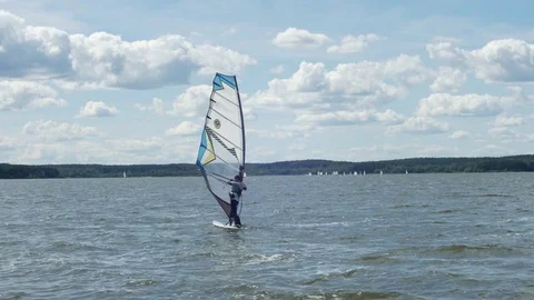 Windsurfer on the water surface. In the background of the bay there are many Stock Footage 78031760