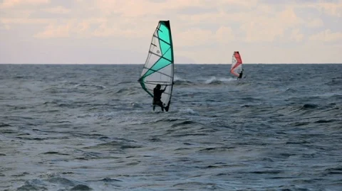 Windsurfers having fun on the sea during a windy day. Video stock 88342901