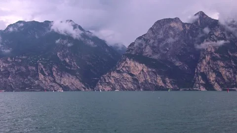 Windsurfers at Lake Garda on cloudy windy day seen from Torbole, Trentino, Italy Stock Footage 279561680