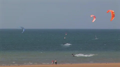 Windsurfers riding the waves on Juno beach, Normandy France Stock Footage 102350041