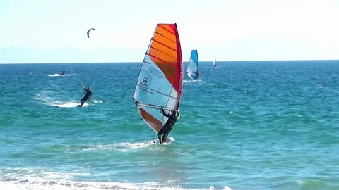 Windsurfers sailing along the beach of Tarifa town Stock Footage 108325453