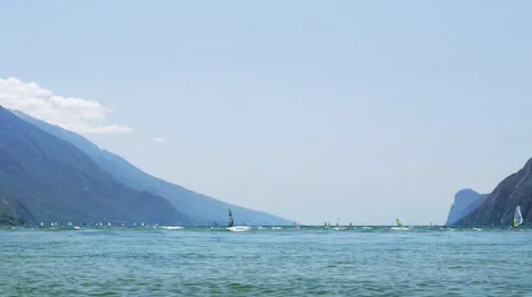 Windsurfers sailing on strong wind and waves at Lake Garda Stock Footage 64744102