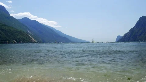 Windsurfers sailing on strong wind and waves at Lake Garda (Lago di Garda or Stock Footage 85397233