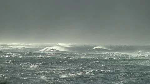 Windsurfers in the waves on Maui, backlit by setting sun Stock Footage 10699303