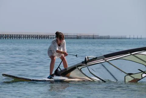 Windsurfing beginner pulling up the sail Stock Photos