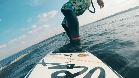 Windsurfing board with a man standing on it while sailing 库存影片 124299203