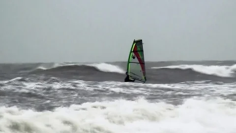 Windsurfing in high waves on the beach. Stock Footage 84327612