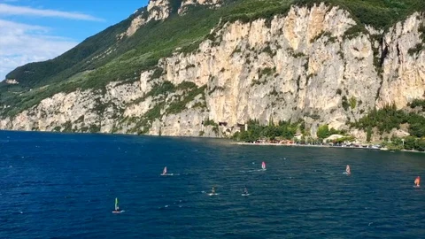 Windsurfing sails on blue water in the background cliffs Stock Footage 113667045