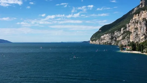 Windsurfing sails on blue water in the background cliffs Stock Footage 113667051