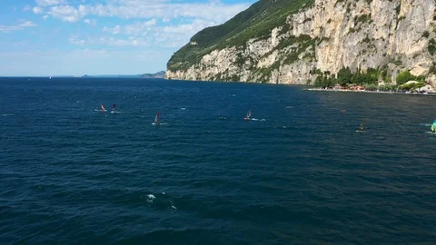Windsurfing sails on blue water in the background cliffs Stock Footage 113667145