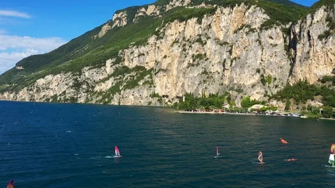 Windsurfing sails on blue water in the background cliffs Stock Footage 113667174