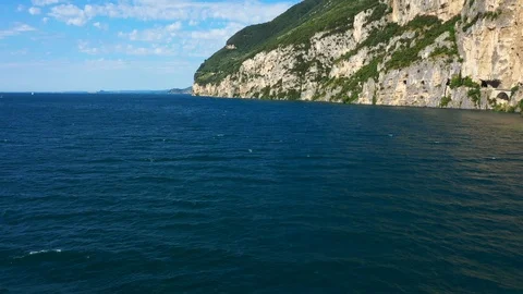 Windsurfing sails on blue water in the background cliffs Stock Footage 113667199