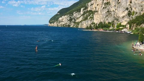 Windsurfing sails on blue water in the background cliffs Stock Footage 113667268