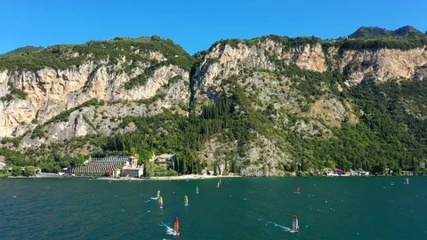 Windsurfing sails on blue water in the background cliffs Stock Footage