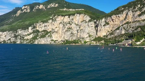 Windsurfing sails on blue water in the background cliffs Stock Footage 113667502