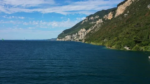 Windsurfing sails on blue water in the background cliffs Stock Footage 113667560