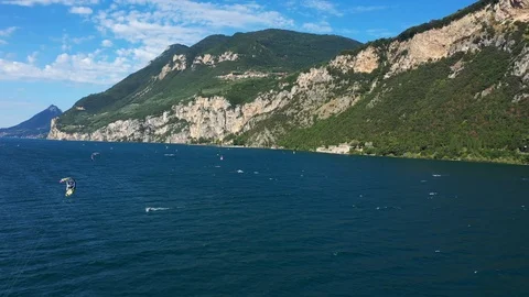 Windsurfing sails on blue water in the background cliffs Stock Footage 113667611