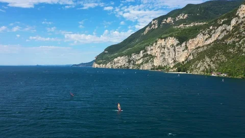 Windsurfing sails on blue water in the background cliffs Stock Footage 113667669