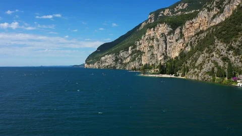 Windsurfing sails on blue water in the background cliffs Stock Footage 113668024