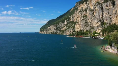 Windsurfing sails on blue water in the background cliffs Stock Footage 113668026