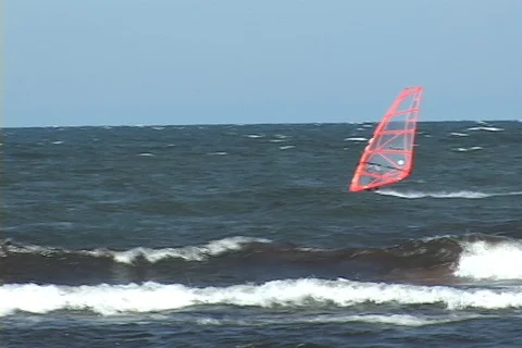 Windsurfing with ship behind, boy swims Stock Footage 124672933