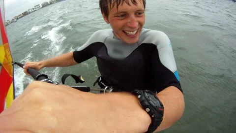 Windsurfing smiling while riding flat water 스톡 동영상 169190321