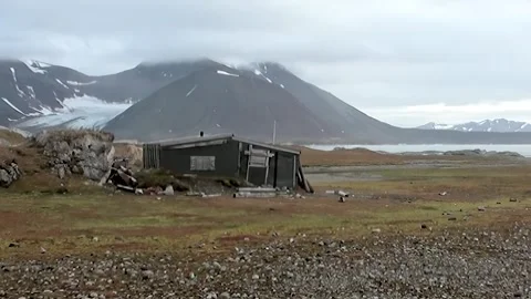 Windswept Cabin Stands Defiant in Wild Arctic Svalbard Stock Footage 340485208