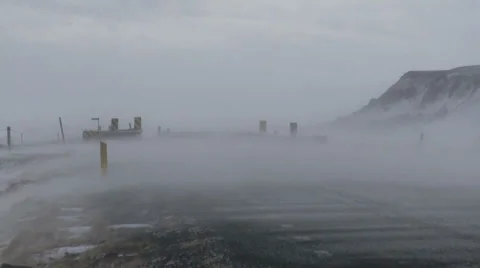 Windswept snow over a road Stock Footage 1106551