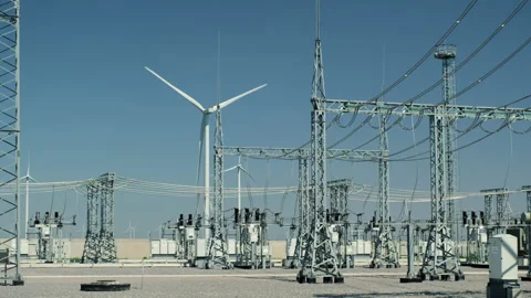 Windturbine generates electricity by high voltage substation Video stock 158164352