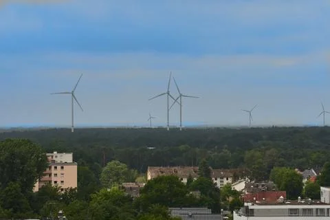 Windturbines on the horizon of a town Stock Photos