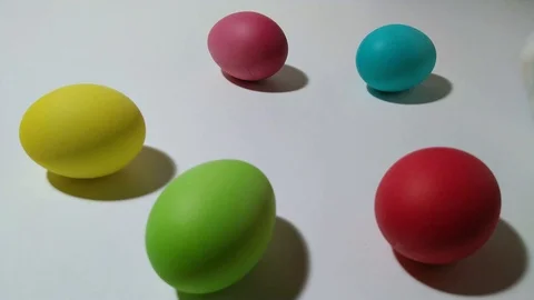 Windup mechanical bunny hops between easter eggs 2 Stock Footage 104923056