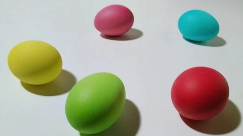 Windup mechanical chick hops between easter eggs 1 Stock Footage 104923420