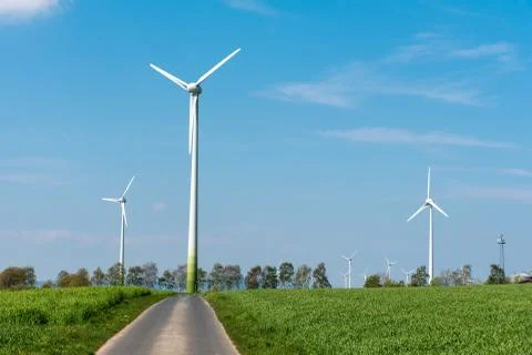 Windwheels and a country road Stock Photos