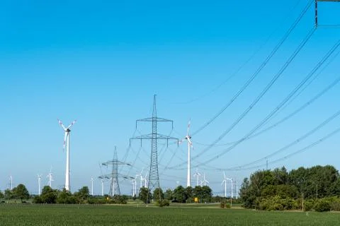 Windwheels and power transmission lines in Germany Stock Photos